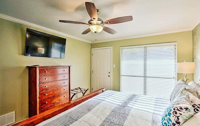 bedroom featuring ceiling fan, visible vents, and ornamental molding