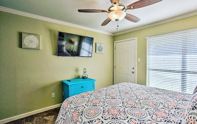 bedroom with ceiling fan, baseboards, ornamental molding, and carpet flooring