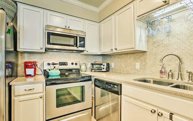 kitchen featuring ornamental molding, a sink, tasteful backsplash, stainless steel appliances, and a toaster