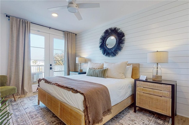 bedroom with hardwood / wood-style flooring, access to outside, french doors, and ceiling fan