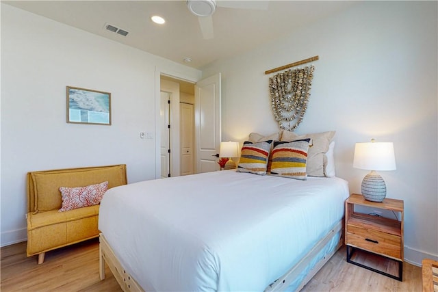 bedroom with ceiling fan and light hardwood / wood-style floors