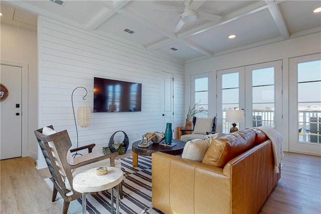 living room featuring coffered ceiling, beam ceiling, and light wood-type flooring