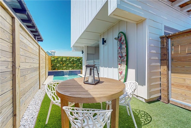 view of patio / terrace featuring a pool and pool water feature