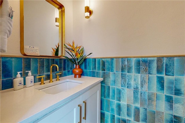 bathroom featuring vanity and tile walls