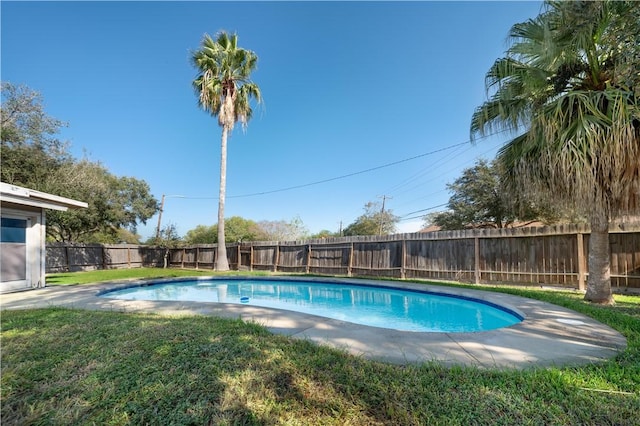 view of pool with a lawn