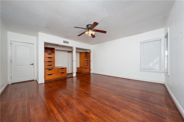 unfurnished bedroom with ceiling fan and dark hardwood / wood-style flooring