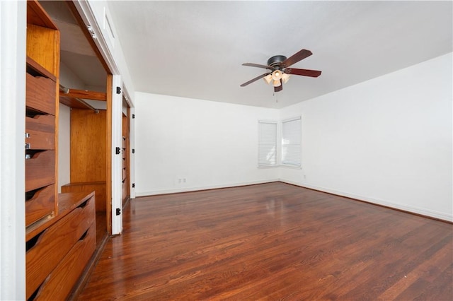 spare room with ceiling fan and dark wood-type flooring