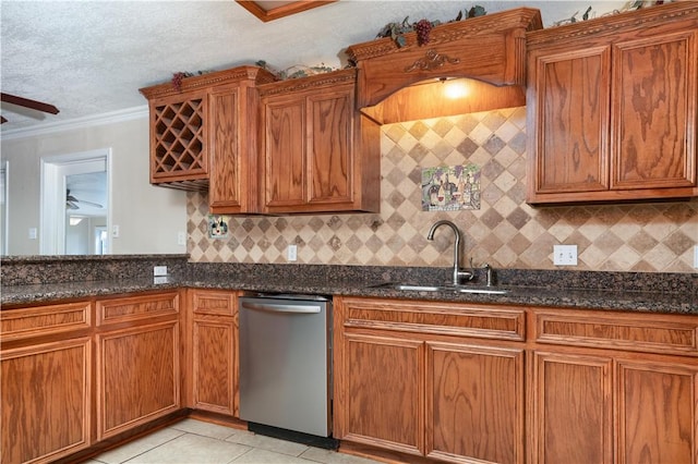 kitchen featuring dishwasher, sink, dark stone countertops, ornamental molding, and tasteful backsplash