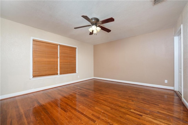 spare room with hardwood / wood-style flooring, ceiling fan, and a textured ceiling