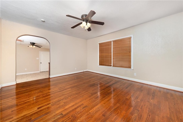 empty room with ceiling fan and wood-type flooring