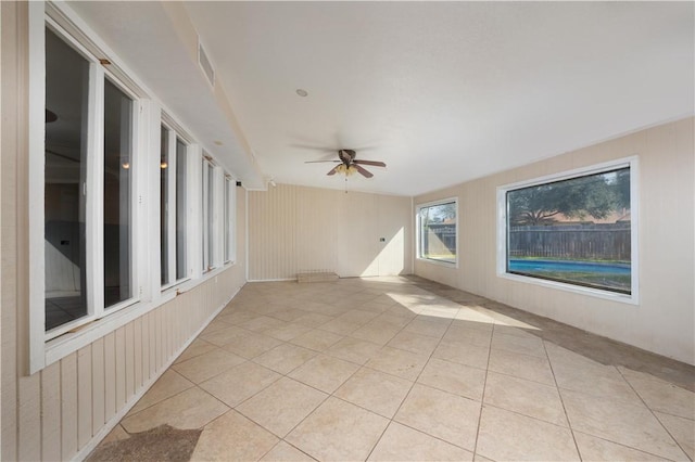 tiled empty room with ceiling fan