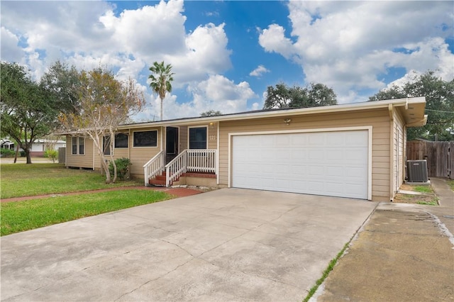 ranch-style home with cooling unit, a front yard, and a garage