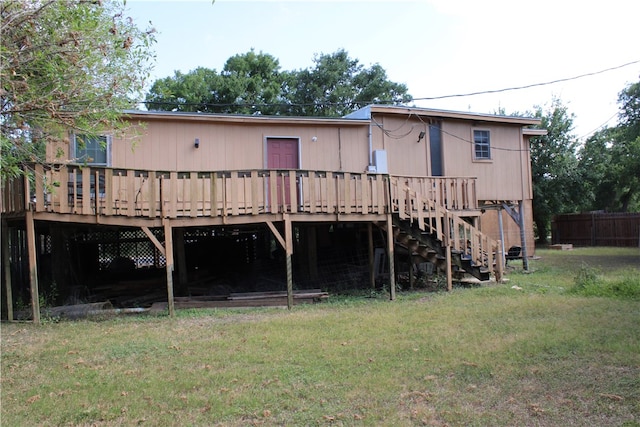 rear view of house with a yard and a wooden deck