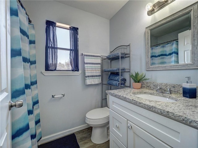 bathroom with vanity, toilet, a shower with shower curtain, and wood-type flooring