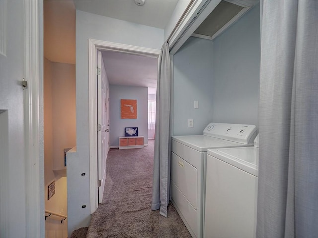 laundry room with light colored carpet and washer and dryer