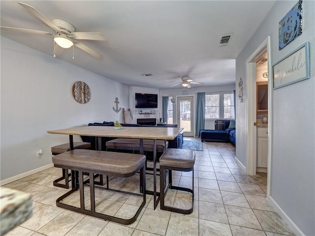 tiled dining area featuring ceiling fan