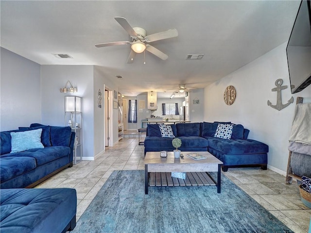 tiled living room featuring ceiling fan