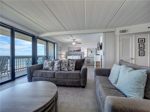 living room featuring a wall of windows, a textured ceiling, and ceiling fan