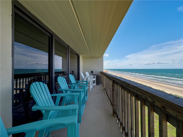 balcony featuring a water view and a view of the beach