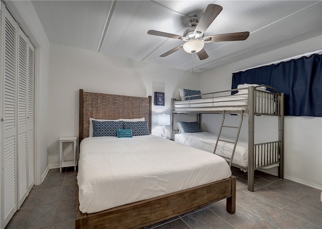 tiled bedroom featuring ceiling fan and a closet