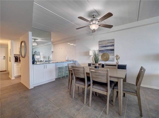 tiled dining room with ceiling fan