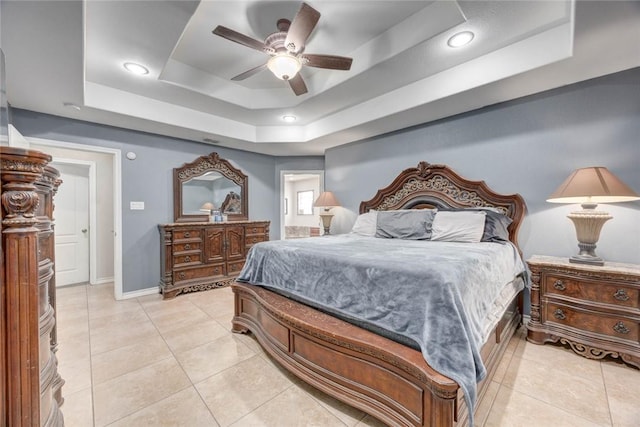 4465 S Oak Cir, Robstown, TX 78380 - bedroom with a tray ceiling, baseboards, light tile patterned floors, ensuite bathroom, and ceiling fan