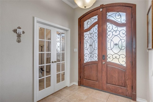4465 S Oak Cir, Robstown, TX 78380 - foyer entrance featuring french doors, light tile patterned floors, crown molding, and baseboards