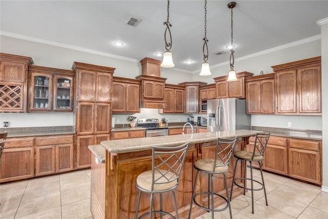 4465 S Oak Cir, Robstown, TX 78380 - kitchen featuring appliances with stainless steel finishes, light tile patterned flooring, an island with sink, a kitchen breakfast bar, and crown molding