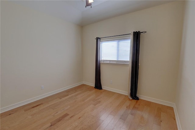 spare room featuring light wood-style flooring and baseboards
