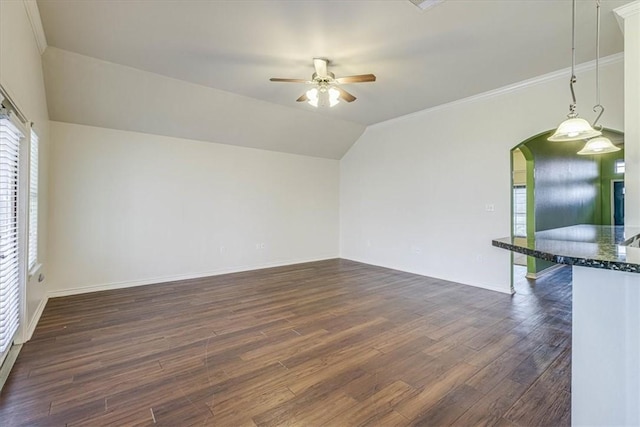 unfurnished living room featuring crown molding, ceiling fan, lofted ceiling, and dark hardwood / wood-style floors