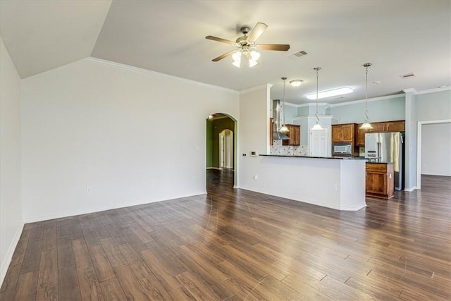 unfurnished living room featuring crown molding, vaulted ceiling, dark hardwood / wood-style floors, and ceiling fan