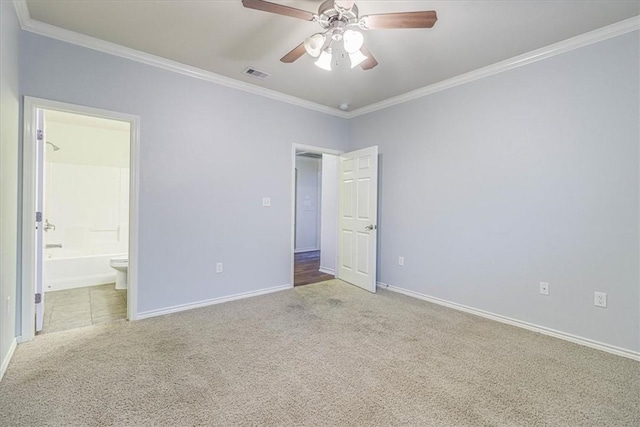 unfurnished bedroom featuring connected bathroom, carpet floors, and ornamental molding