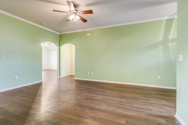 spare room featuring dark wood-type flooring, ornamental molding, and ceiling fan