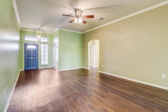 foyer entrance with dark wood-type flooring, ornamental molding, and ceiling fan