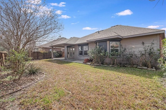 back of property featuring a yard and a patio