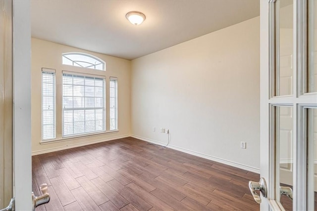 spare room featuring hardwood / wood-style floors