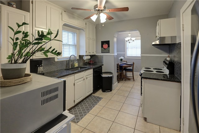 kitchen featuring white cabinets, black dishwasher, sink, light tile patterned flooring, and backsplash