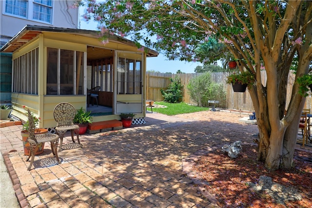 view of patio featuring a sunroom