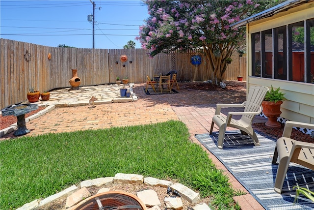 view of yard featuring a patio and a sunroom