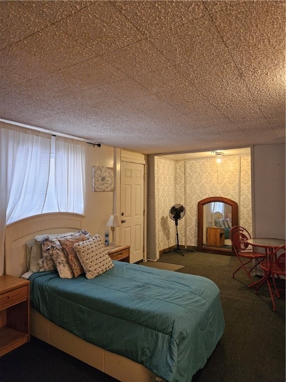 bedroom featuring a textured ceiling and carpet floors