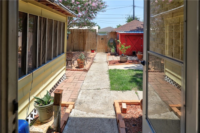 view of yard featuring a patio and a storage unit