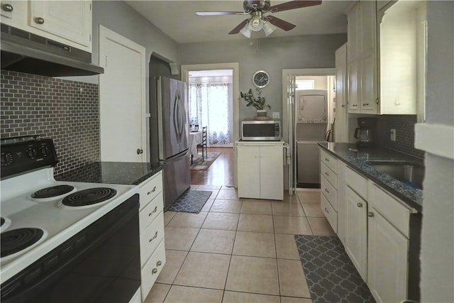 kitchen featuring white cabinetry, appliances with stainless steel finishes, light tile patterned floors, and tasteful backsplash