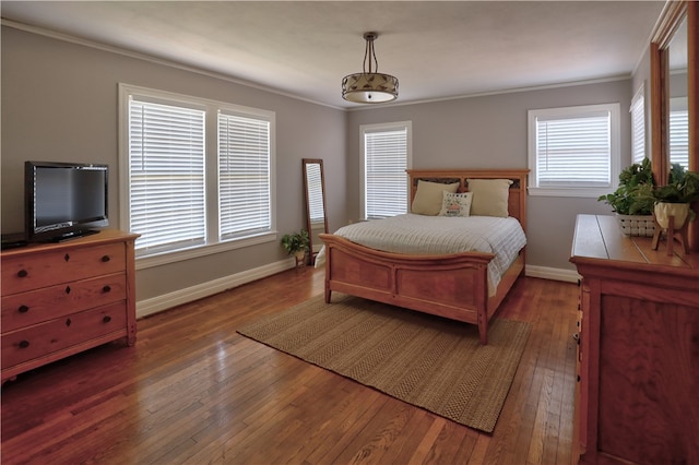 bedroom with dark wood-type flooring, multiple windows, and ornamental molding