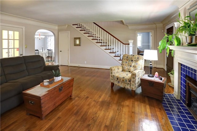 501 Del Mar Blvd, Corpus Christi, TX 78404 - living room with stairway, arched walkways, a tiled fireplace, wood-type flooring, and ornamental molding
