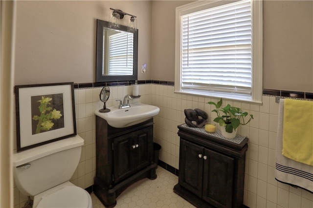 bathroom featuring tile walls, vanity, and plenty of natural light