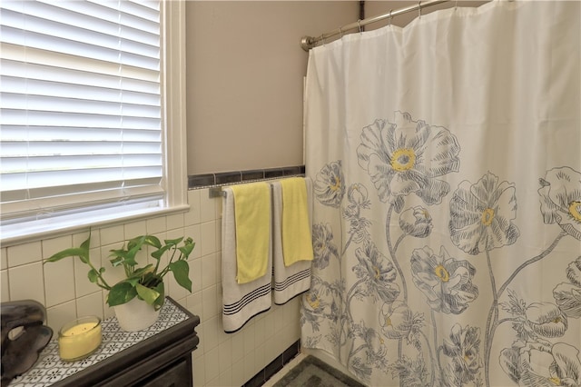 bathroom with tile walls