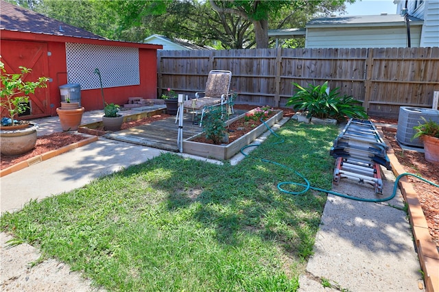 view of yard featuring central AC and a storage shed