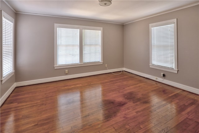 spare room with ornamental molding, dark hardwood / wood-style floors, and plenty of natural light