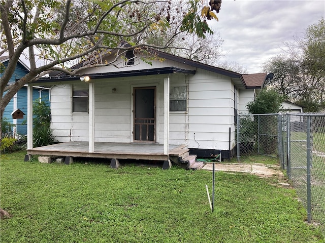 rear view of property featuring a yard