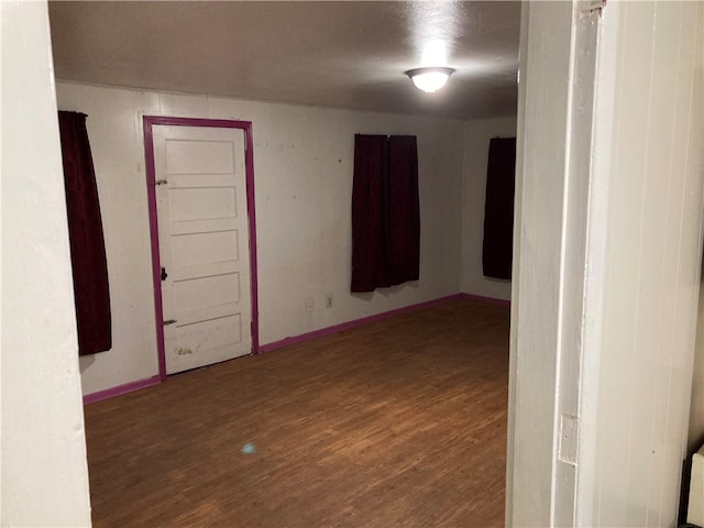 empty room with hardwood / wood-style flooring